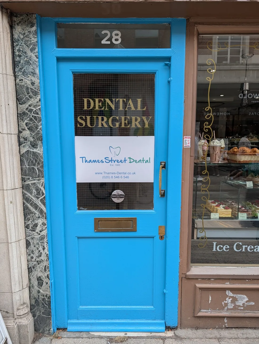 The blue front door of Thames Street Dental at 28 Thames Street, Kingston upon Thames