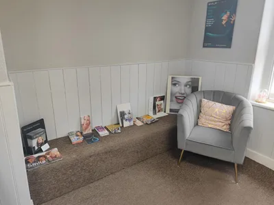 Bench seating and an armchair along the waiting room wall